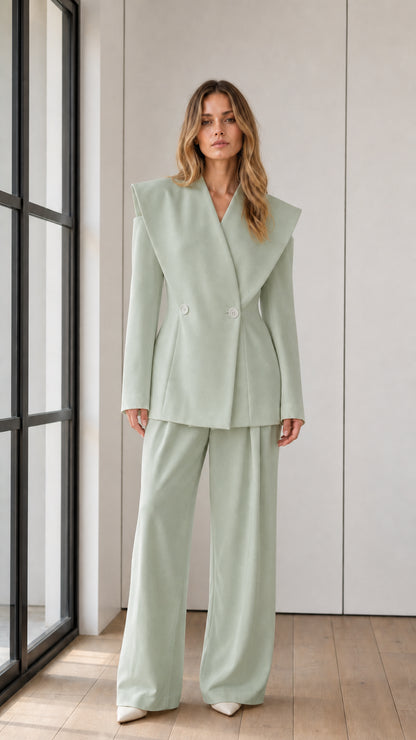 Full-length front view of model in sage green dramatic shawl lapel suit set