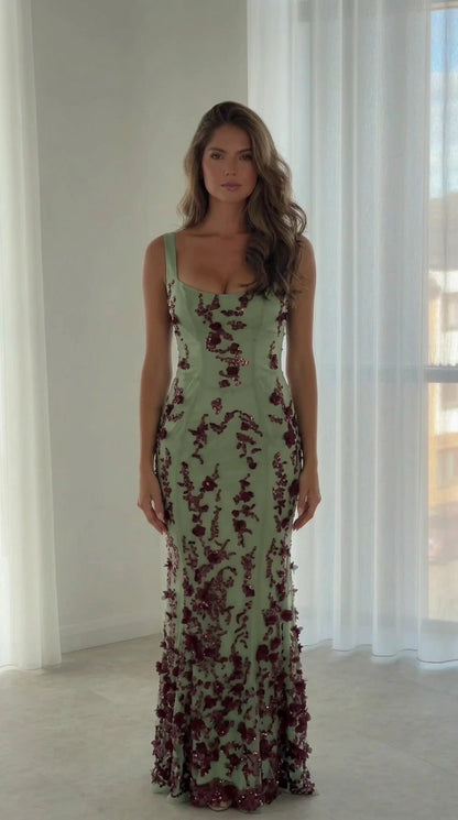 Front view of model wearing sage green sequin floral embroidered evening gown