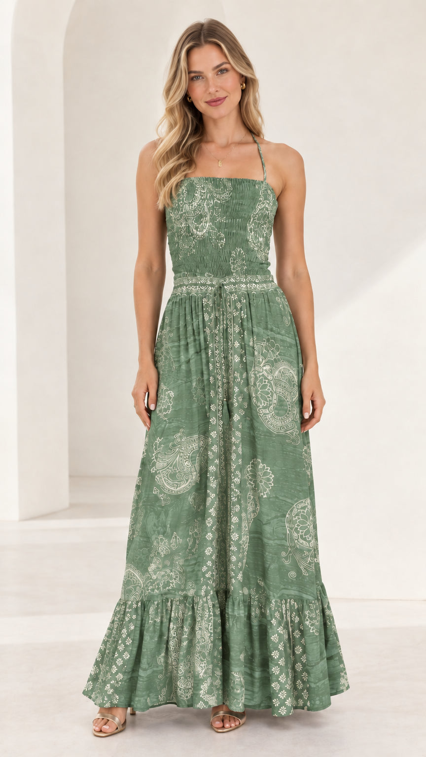 Full-length front view of sage green printed smocked tiered maxi dress
