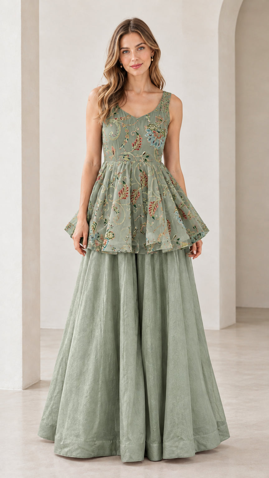 Front view of model wearing sage green embroidered peplum top and pants set