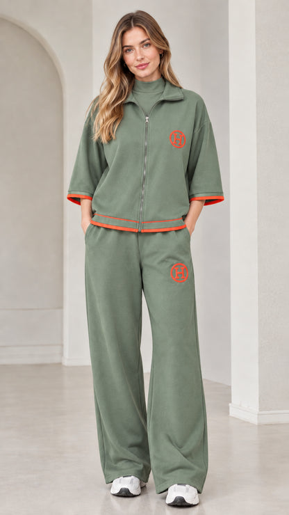 Front view of woman wearing sage green two-piece zip-up tracksuit set
