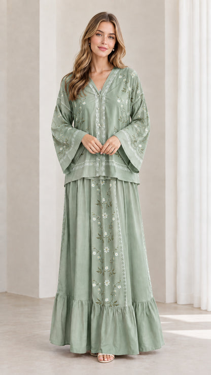 Model wearing sage green floral embroidered two-piece maxi skirt set