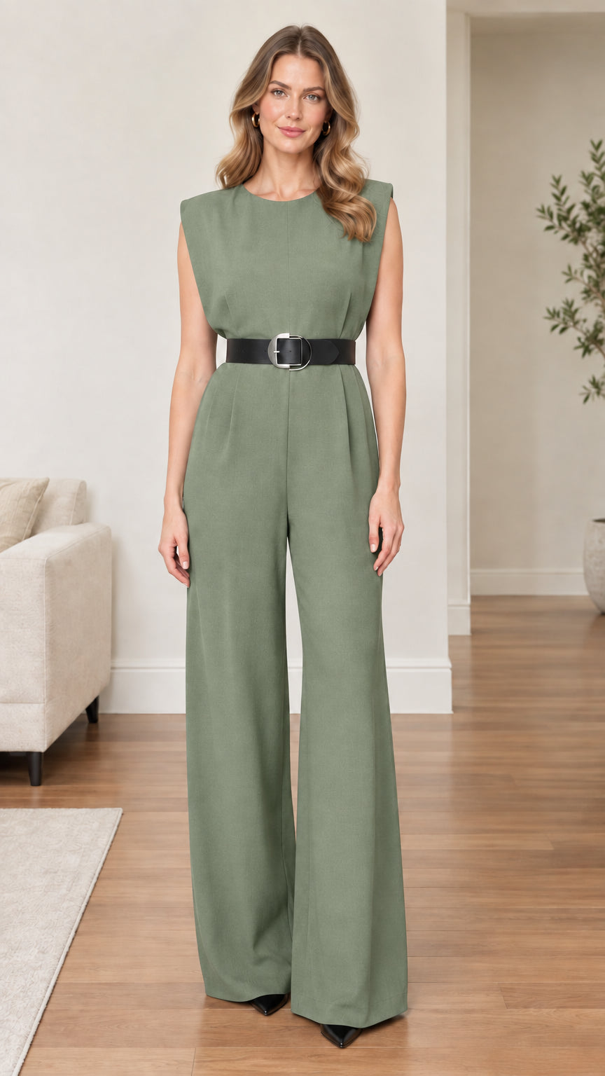 Model wearing sage green sleeveless wide-leg jumpsuit with black belt