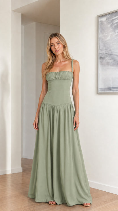 Model wearing sage green sleeveless gathered drop waist maxi gown