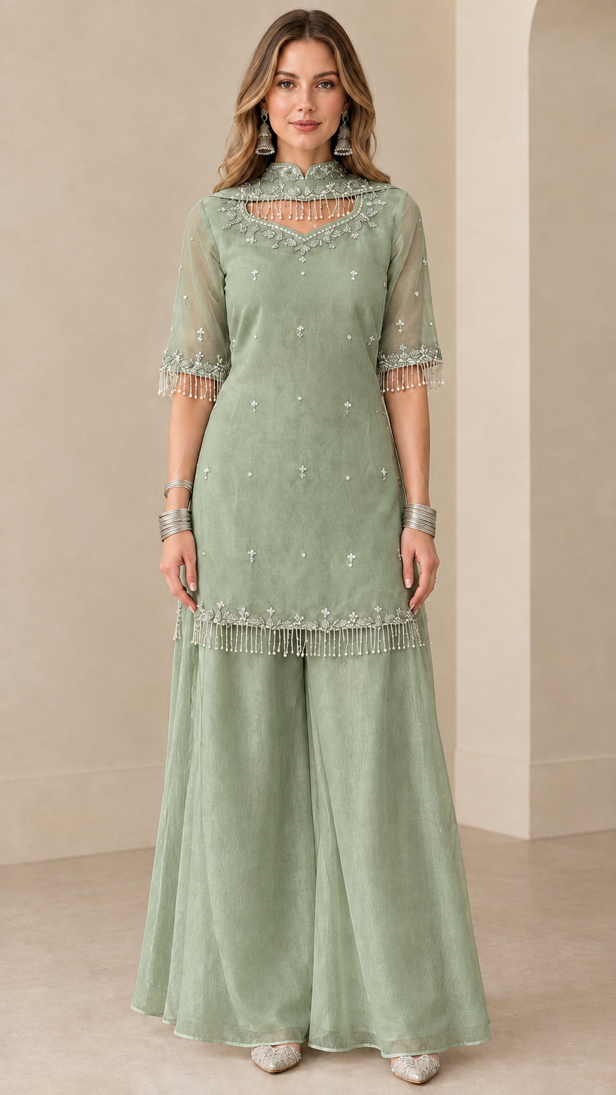 Front view of sage green embroidered kurti sharara suit set