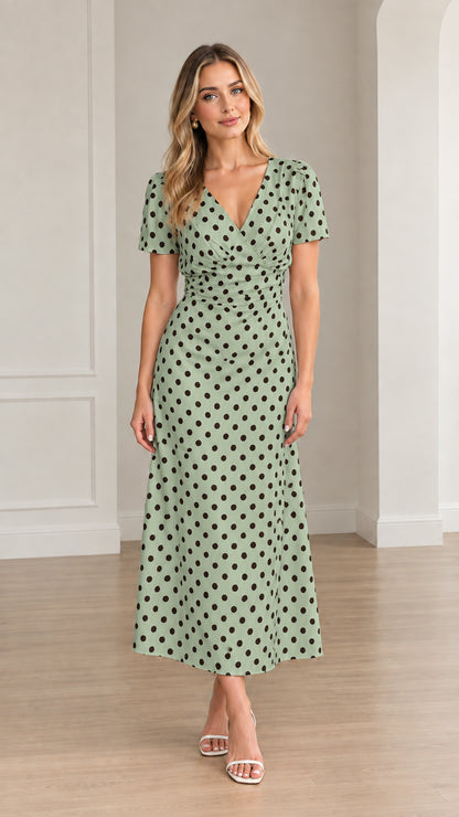 Front view of woman wearing sage green polka dot short sleeve midi dress