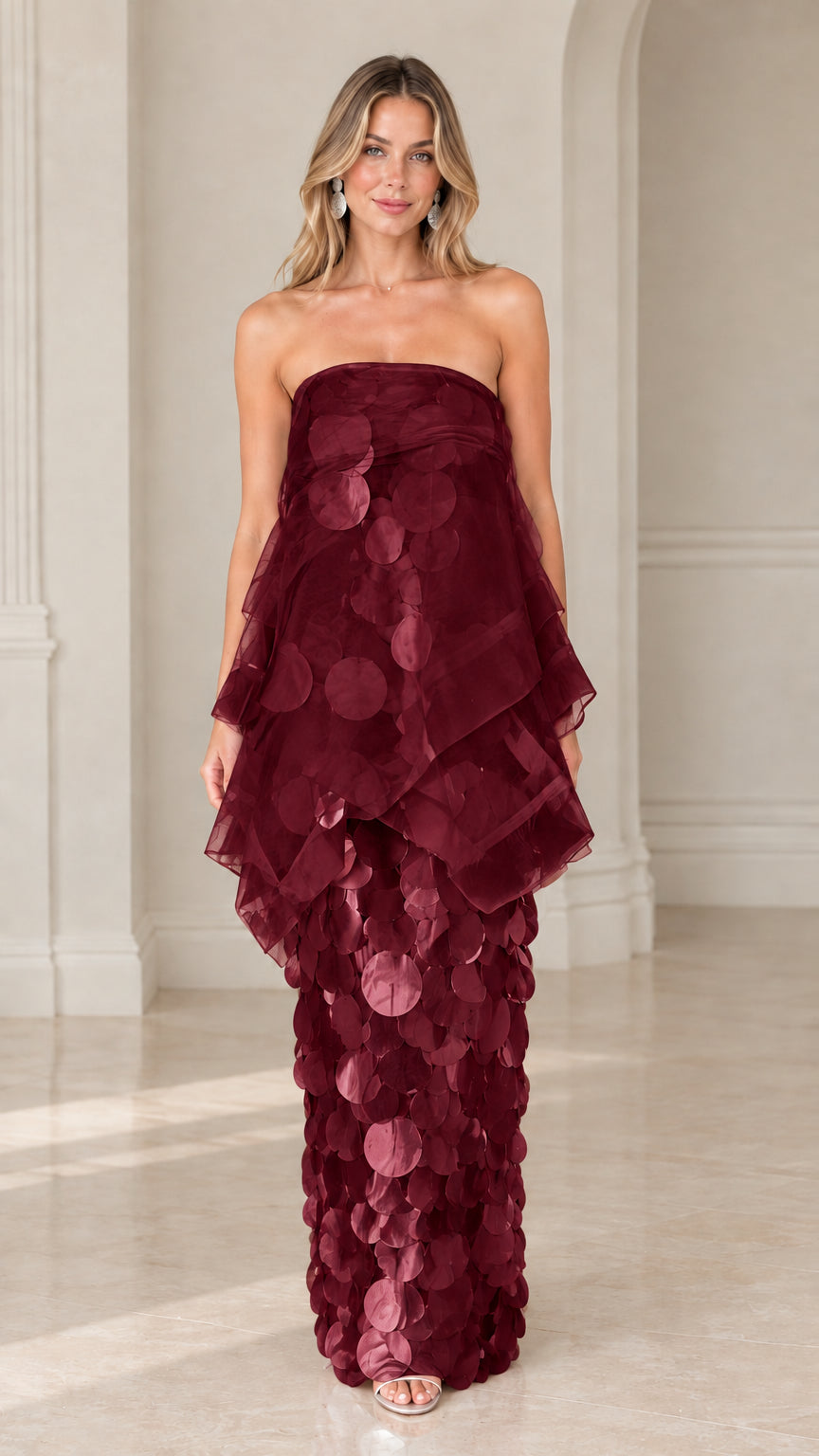 Front view of model wearing burgundy strapless tiered organza paillette maxi dress