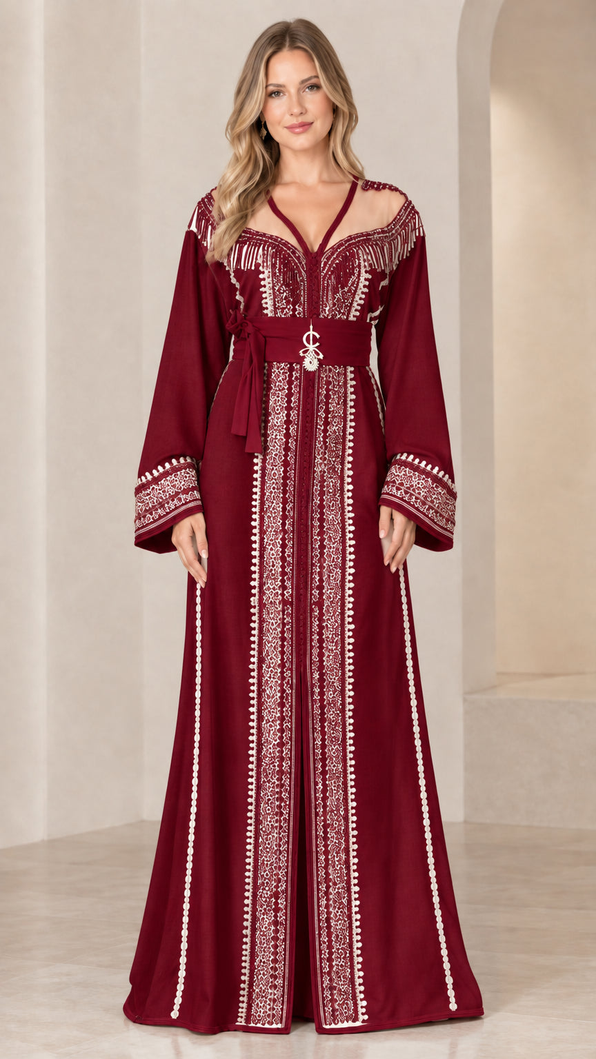 Model wearing burgundy red caftan gown with ornate silver-white embroidery