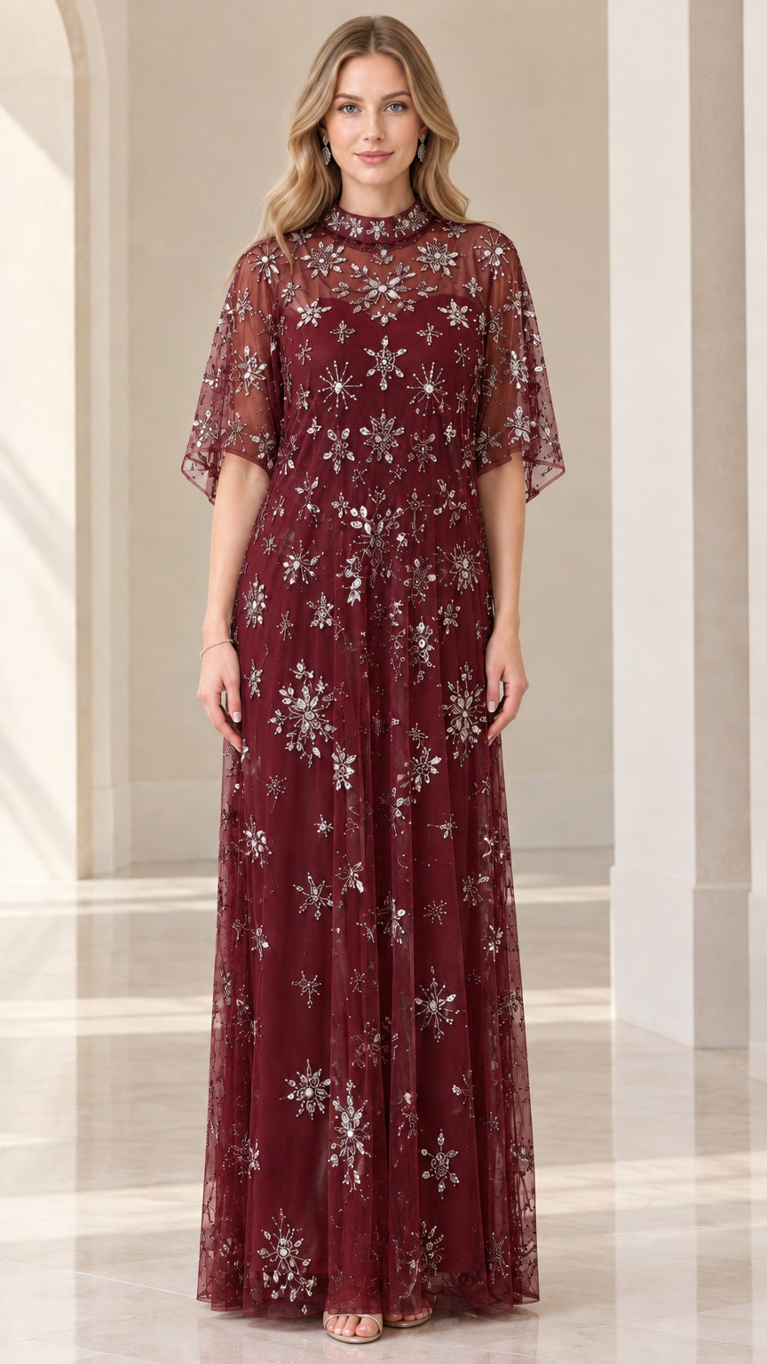 Front view of woman wearing burgundy starburst beaded formal maxi dress