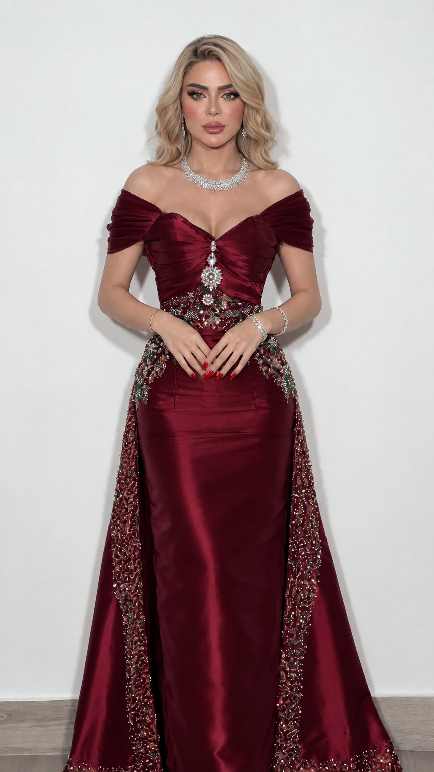 Model wearing burgundy wine red off-the-shoulder evening gown with embellished waist