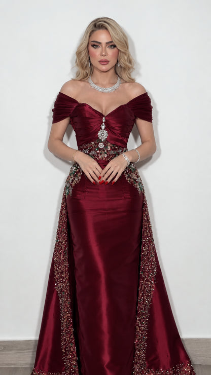 Model wearing burgundy wine red off-the-shoulder evening gown with embellished waist