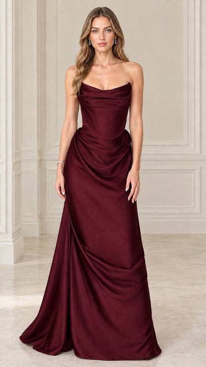 Model wearing burgundy red strapless satin corset draped maxi dress