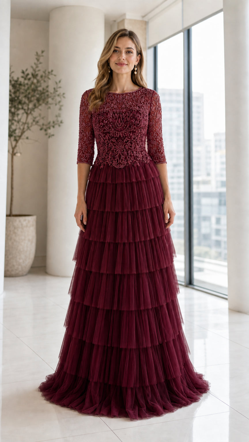 Front view of model wearing Burgundy beaded bodice tiered tulle evening gown