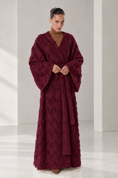 Front full view of woman wearing burgundy wine textured chevron fringe maxi wrap robe