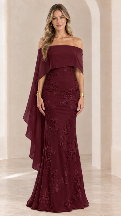 Woman wearing burgundy wine off-the-shoulder embroidered cape evening gown