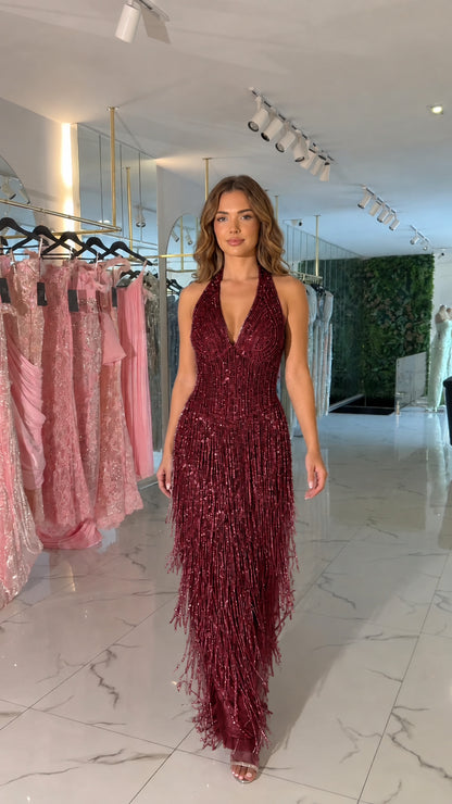 Front view of burgundy red halter beaded fringe evening maxi dress