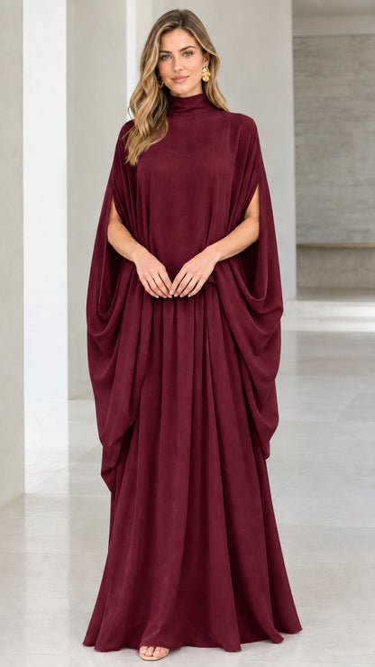 Front view of model wearing burgundy high neck cape sleeve maxi dress