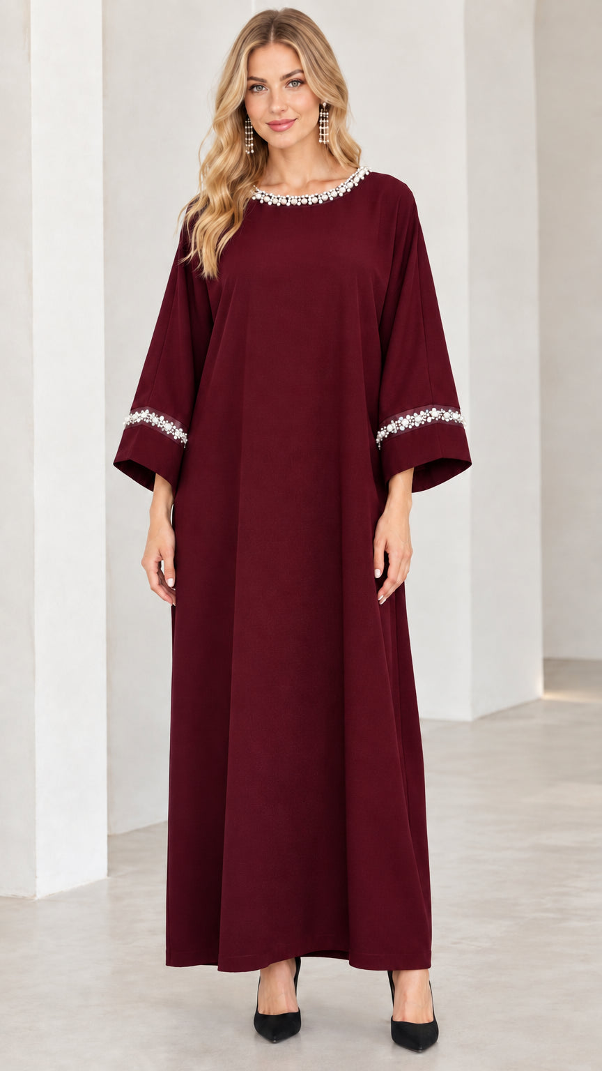 Front view of woman wearing burgundy wine red pearl trim abaya dress