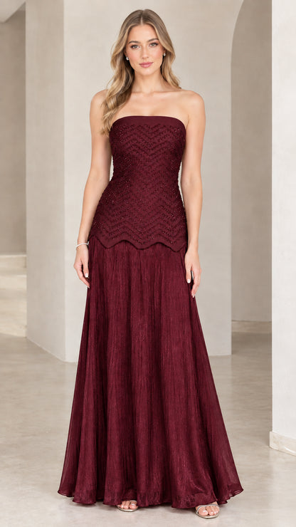 Full-length view of model in burgundy wine strapless beaded evening dress