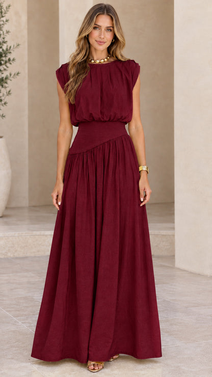 Model wearing burgundy red sleeveless pleated maxi dress
