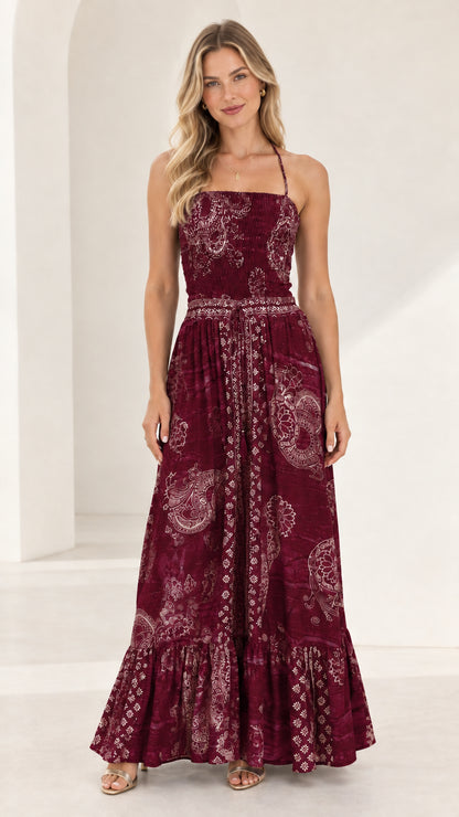 Full-length front view of burgundy wine printed smocked tiered maxi dress