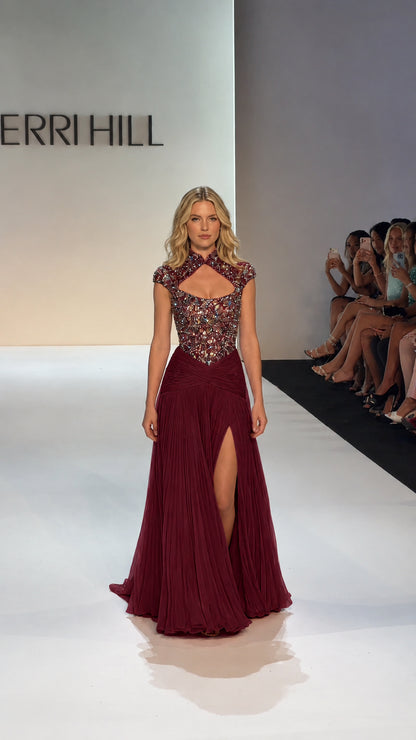 Full-length view of model wearing Burgundy formal gown with keyhole cutout and pleated skirt