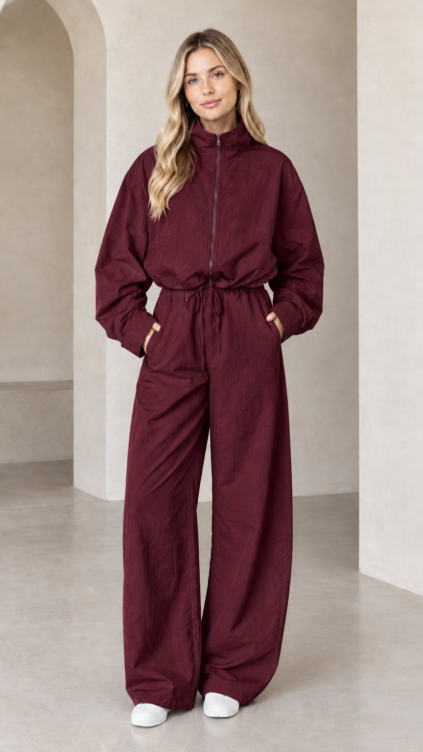 Front full-length view of woman wearing Burgundy zip-up wide-leg utility jumpsuit