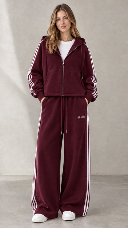 Woman wearing Burgundy two-piece hooded sweatshirt and wide-leg pants set