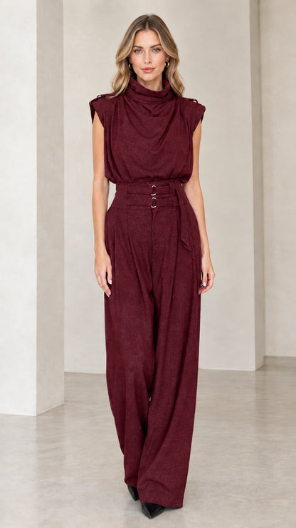Model wearing burgundy wine sleeveless drape high neck wide leg jumpsuit