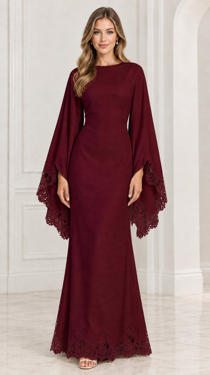 Front view of model wearing burgundy red cape sleeve formal gown with lace hem