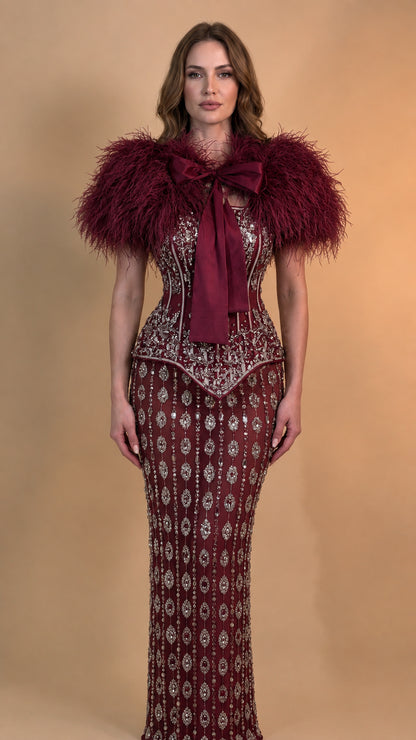 Front view of model wearing Burgundy wine red feather trim sequin corset gown