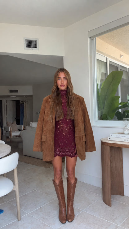 Full front view of model wearing camel faux suede blazer with wine burgundy lace dress