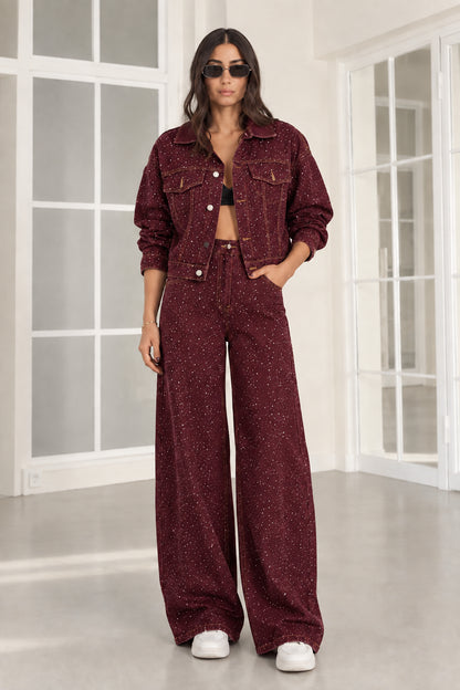 Model wearing burgundy wine rhinestone denim cropped jacket and wide-leg jeans set