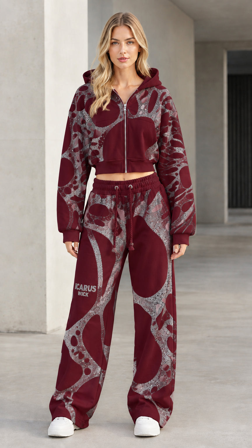 Front view of model wearing burgundy graphic cropped zip hoodie and wide-leg sweatpants