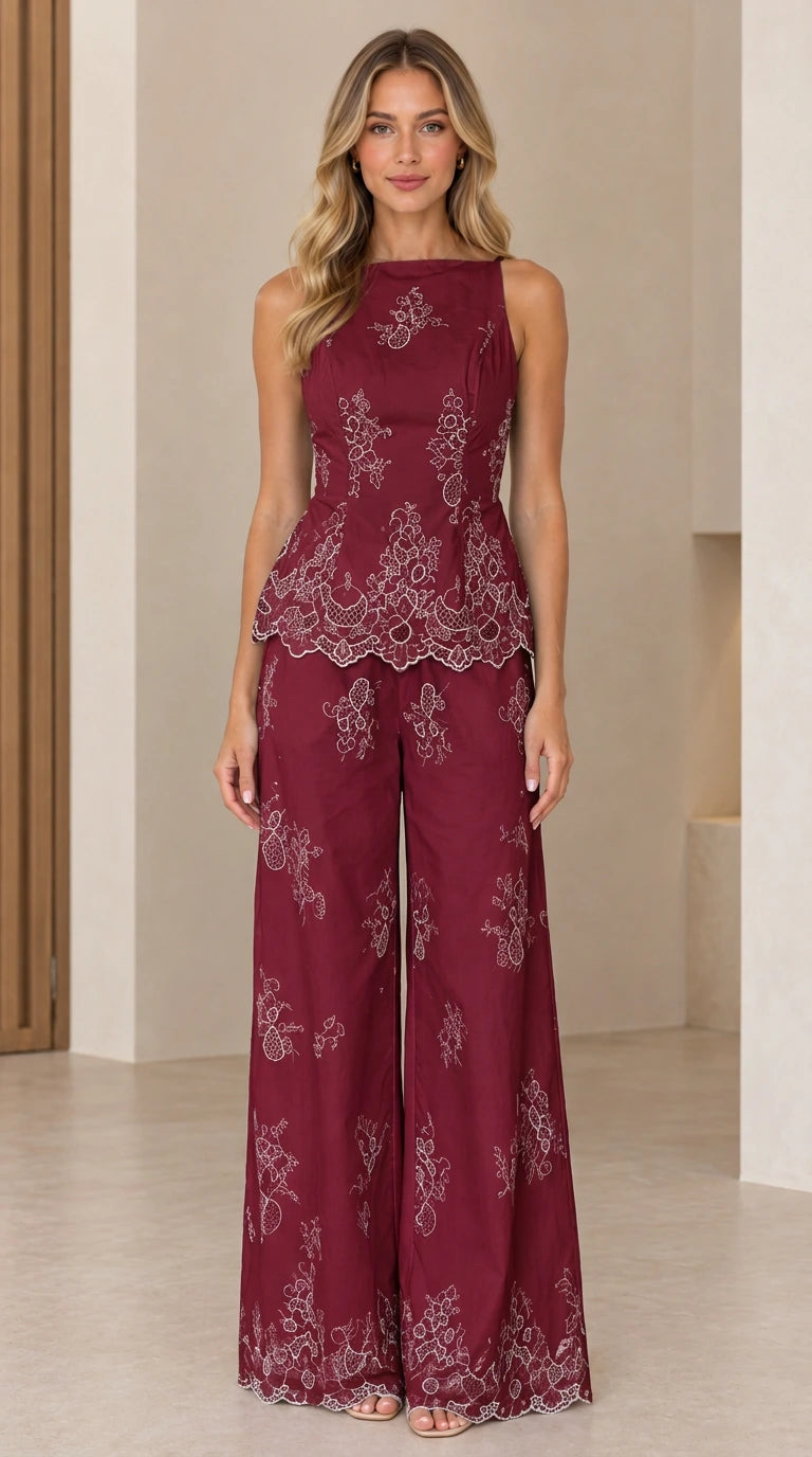 Full length view of model wearing burgundy embroidered peplum top and wide leg pants