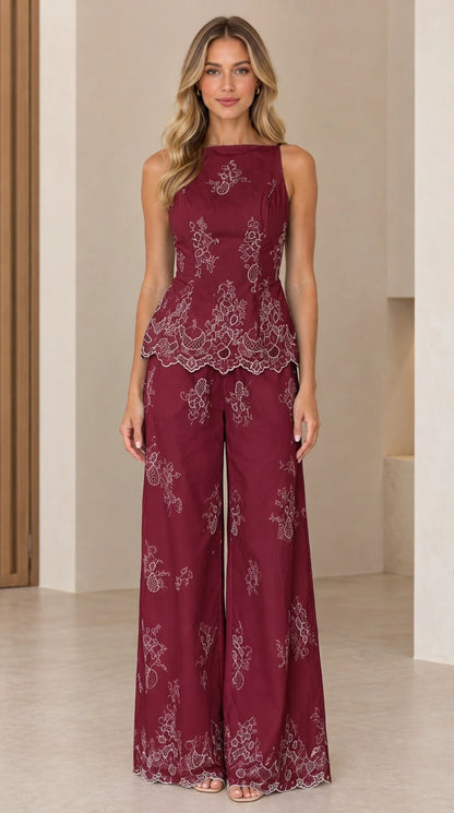 Full length view of model wearing burgundy embroidered peplum top and wide leg pants