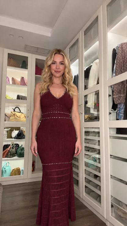 Front view of woman wearing burgundy sleeveless knit evening maxi dress