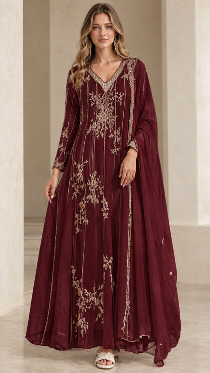 Model wearing rich burgundy embroidered evening gown with matching scarf
