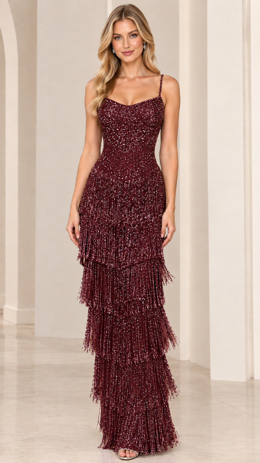Model wearing Burgundy wine sequin tiered fringe formal gown
