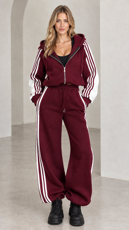 Front view of model wearing burgundy wine red two-piece striped tracksuit set
