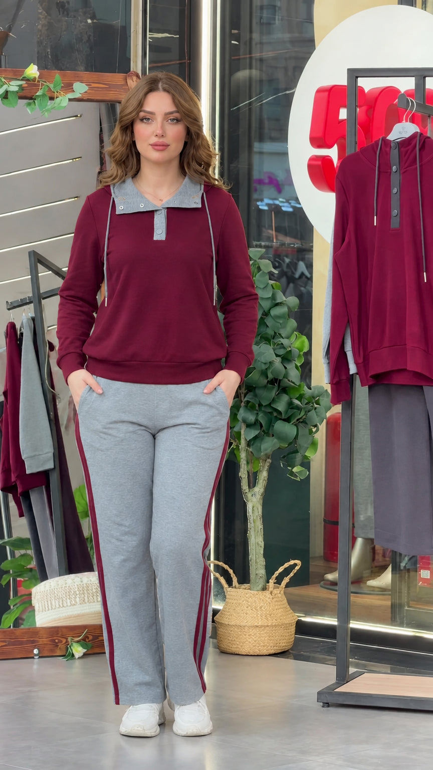 Model wearing burgundy long sleeve top with grey collar and side-stripe track pants
