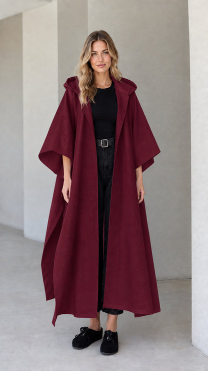 Model wearing burgundy wine red hooded maxi canvas cape coat