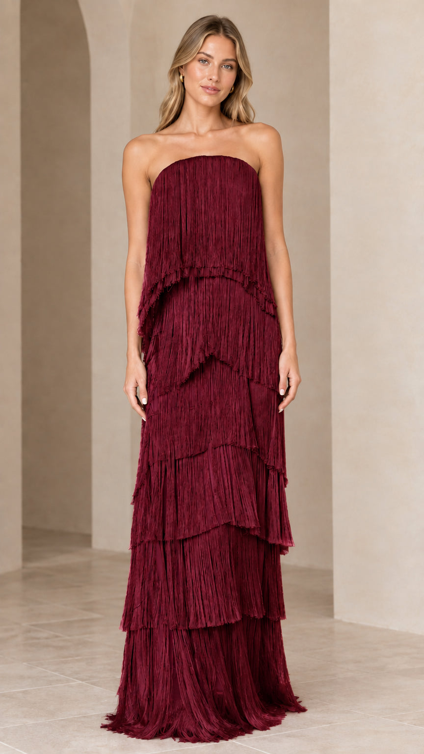 Full-length view of strapless tiered fringe maxi dress in burgundy