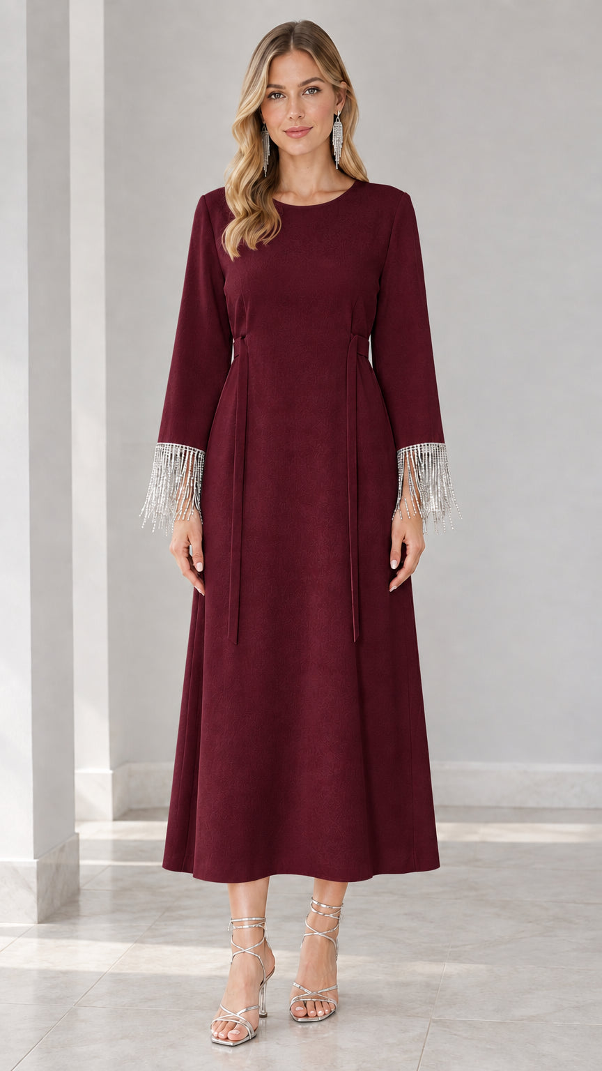 Front view of burgundy wine long sleeve formal maxi dress with fringe cuffs