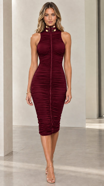 Front full-length view of woman wearing burgundy ruched sleeveless midi dress with gold collar