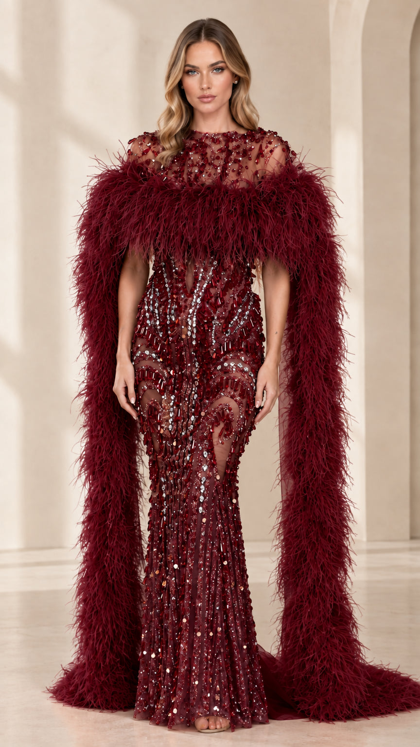Full-length view of burgundy beaded evening gown with dramatic wine feather cape
