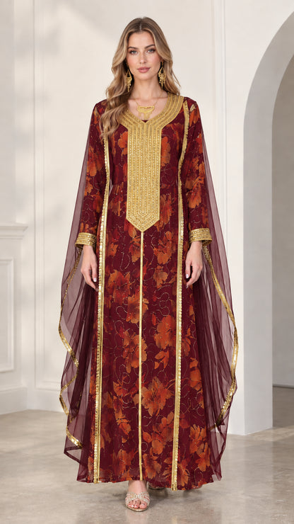 Model wearing burgundy floral kaftan dress with gold bib embroidery and sheer draped sleeves