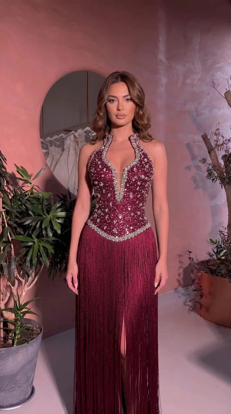 Front view of model wearing Burgundy embellished fringe halter maxi dress