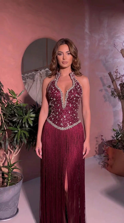 Front view of model wearing Burgundy embellished fringe halter maxi dress