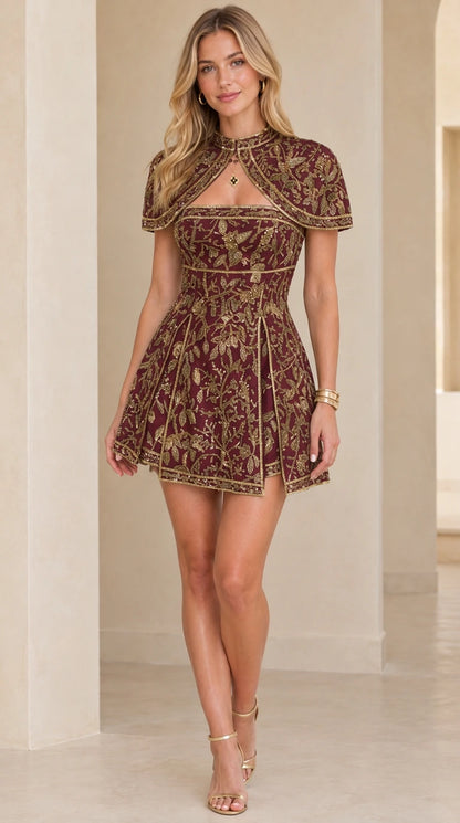 Front view of model wearing burgundy wine embroidered capelet mini dress